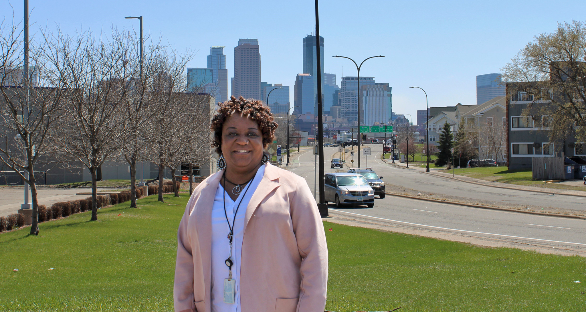 Woman standing in front of Minneapolis skyline. 