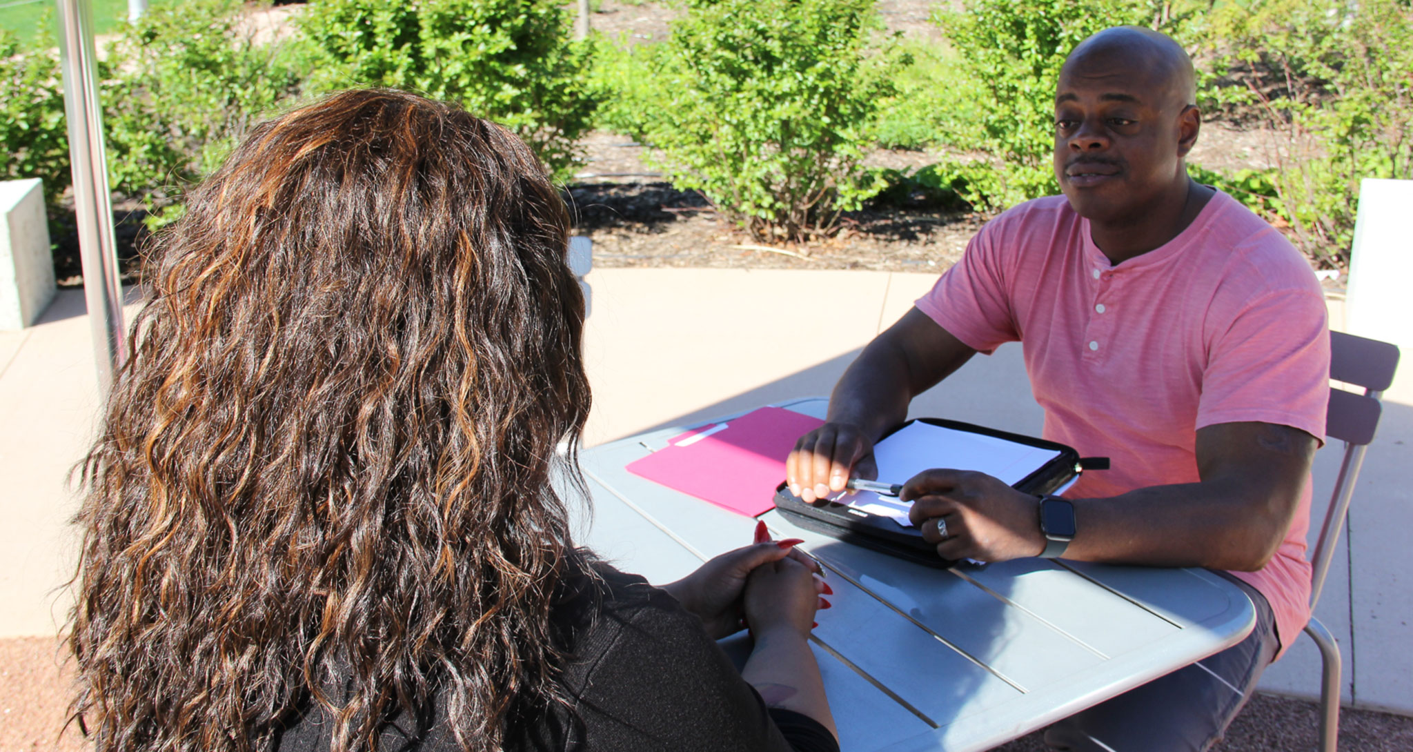 Tyrone Patterson, a psychiatric social worker and mental health survivor, meeting with a client in the park.