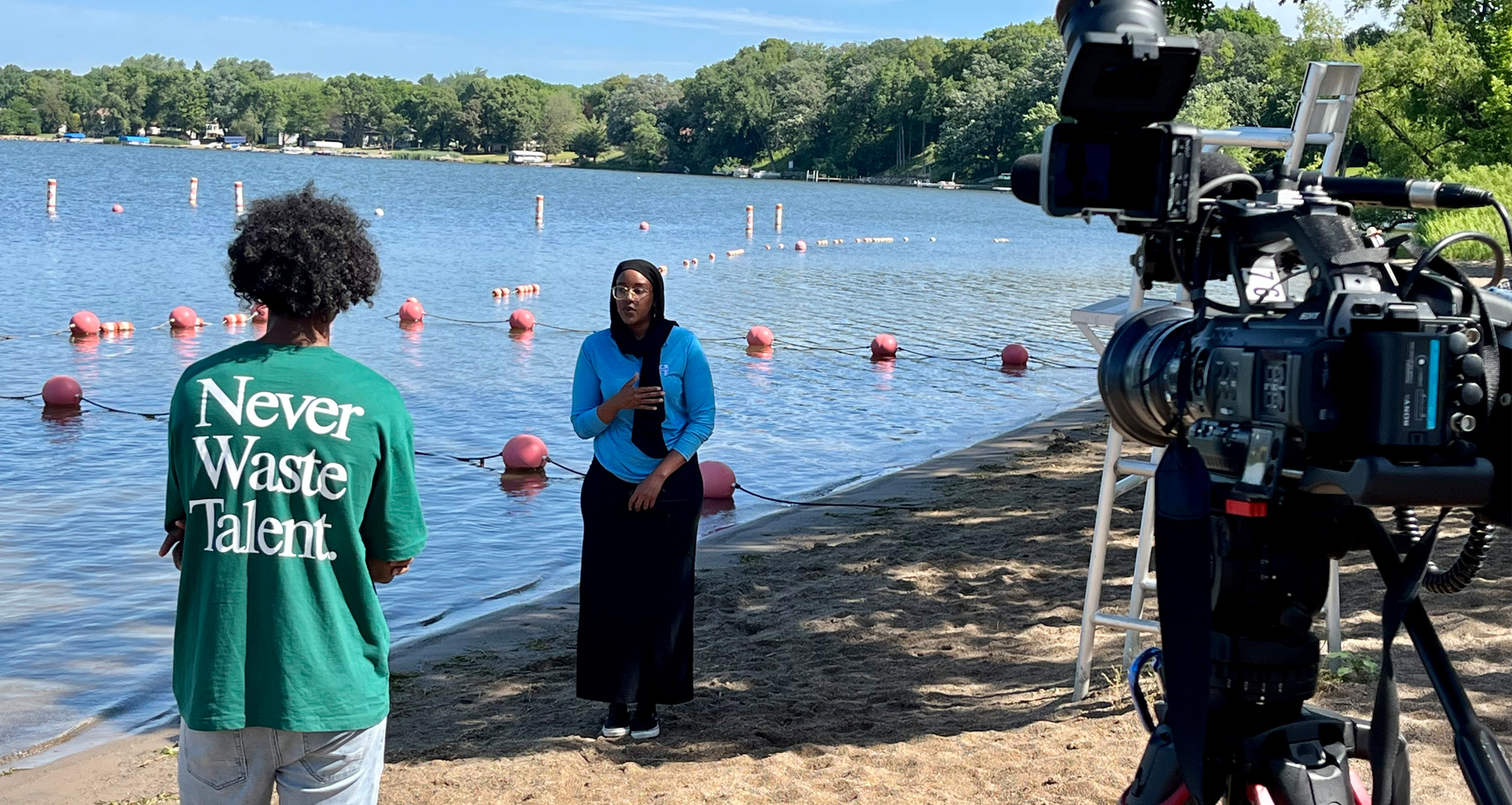 Hennepin County officials being filmed taking water samples at a beach  