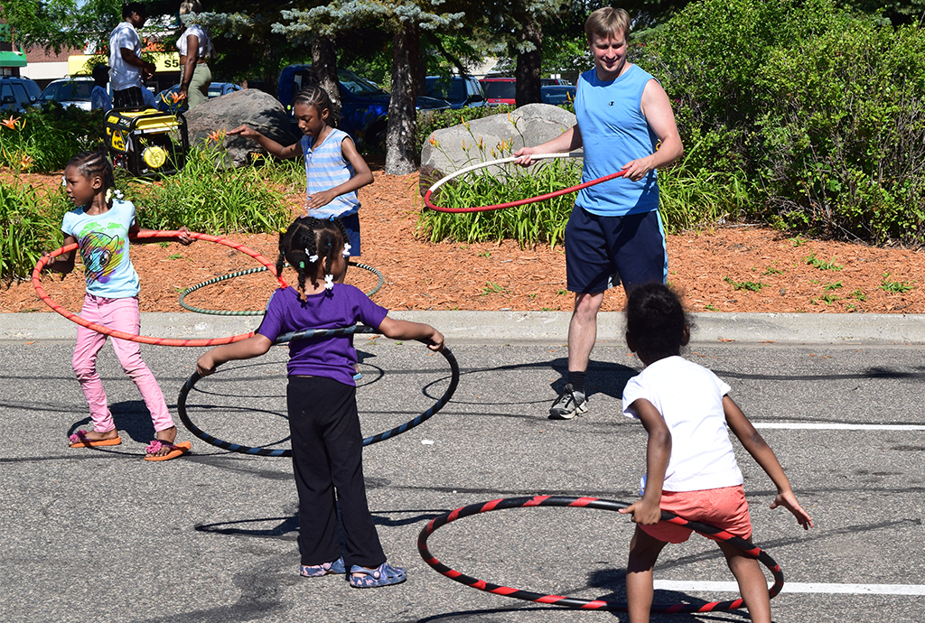 Young kids learning how to hula hoop