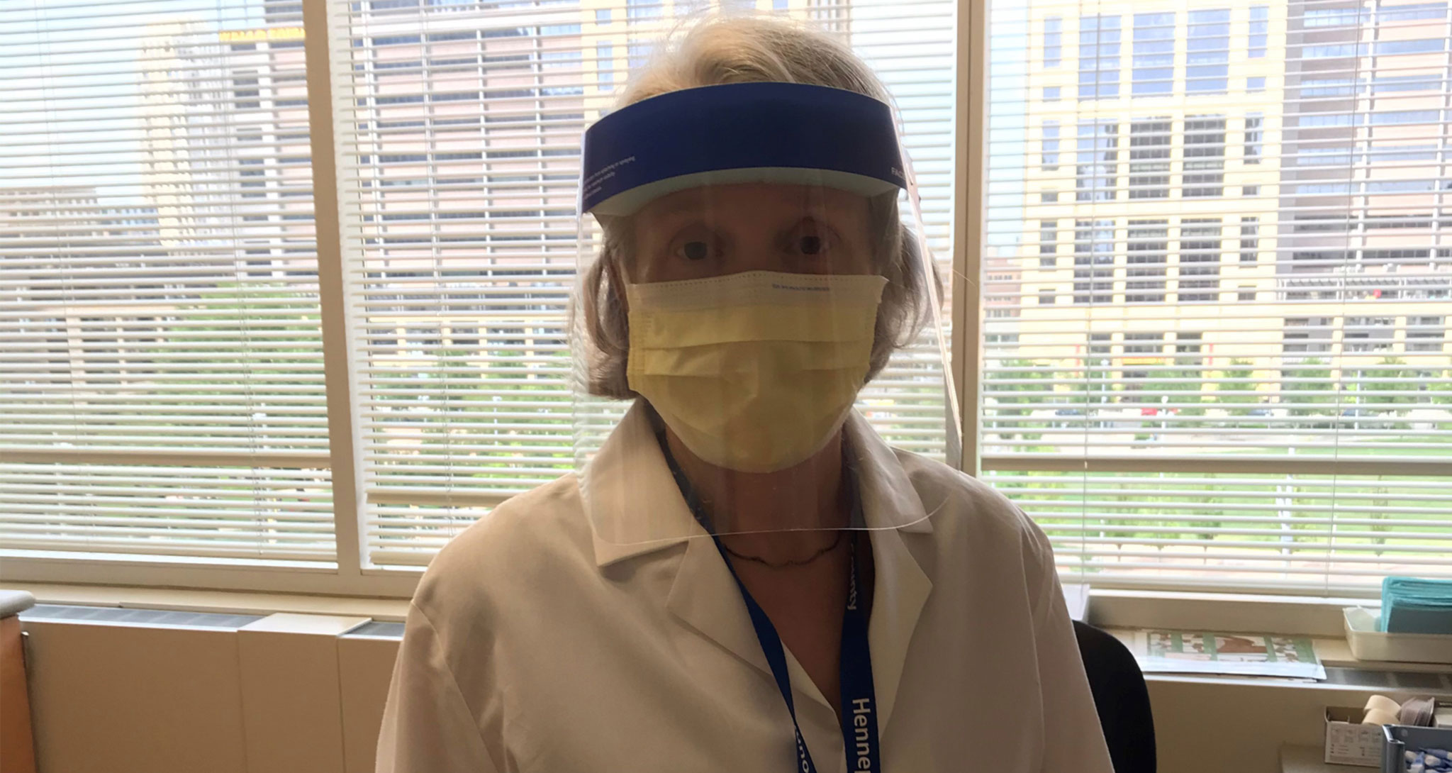 Nurse at the Public Health Clinic wearing a facemask and face shield