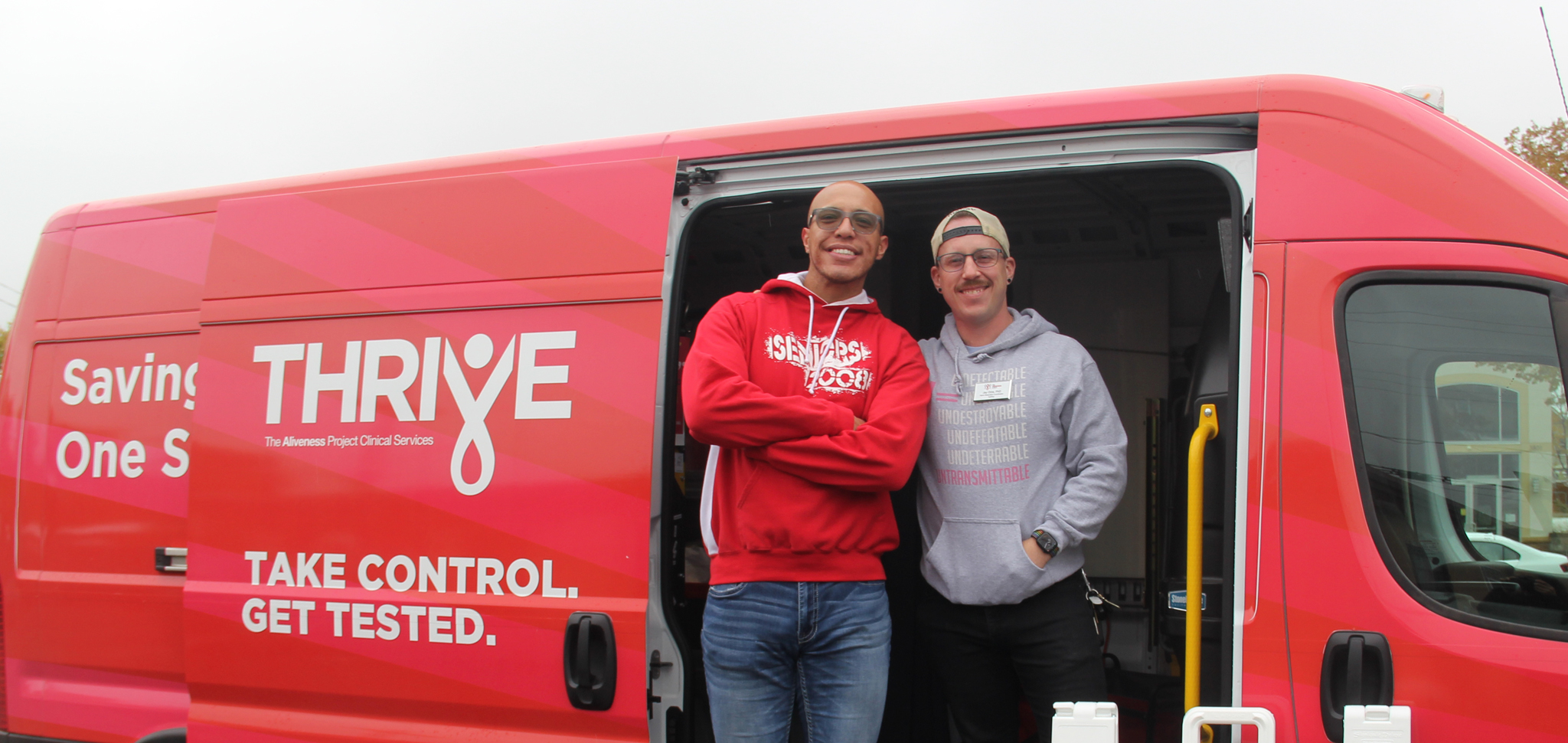 Aliveness Project staff standing in front of mobile van