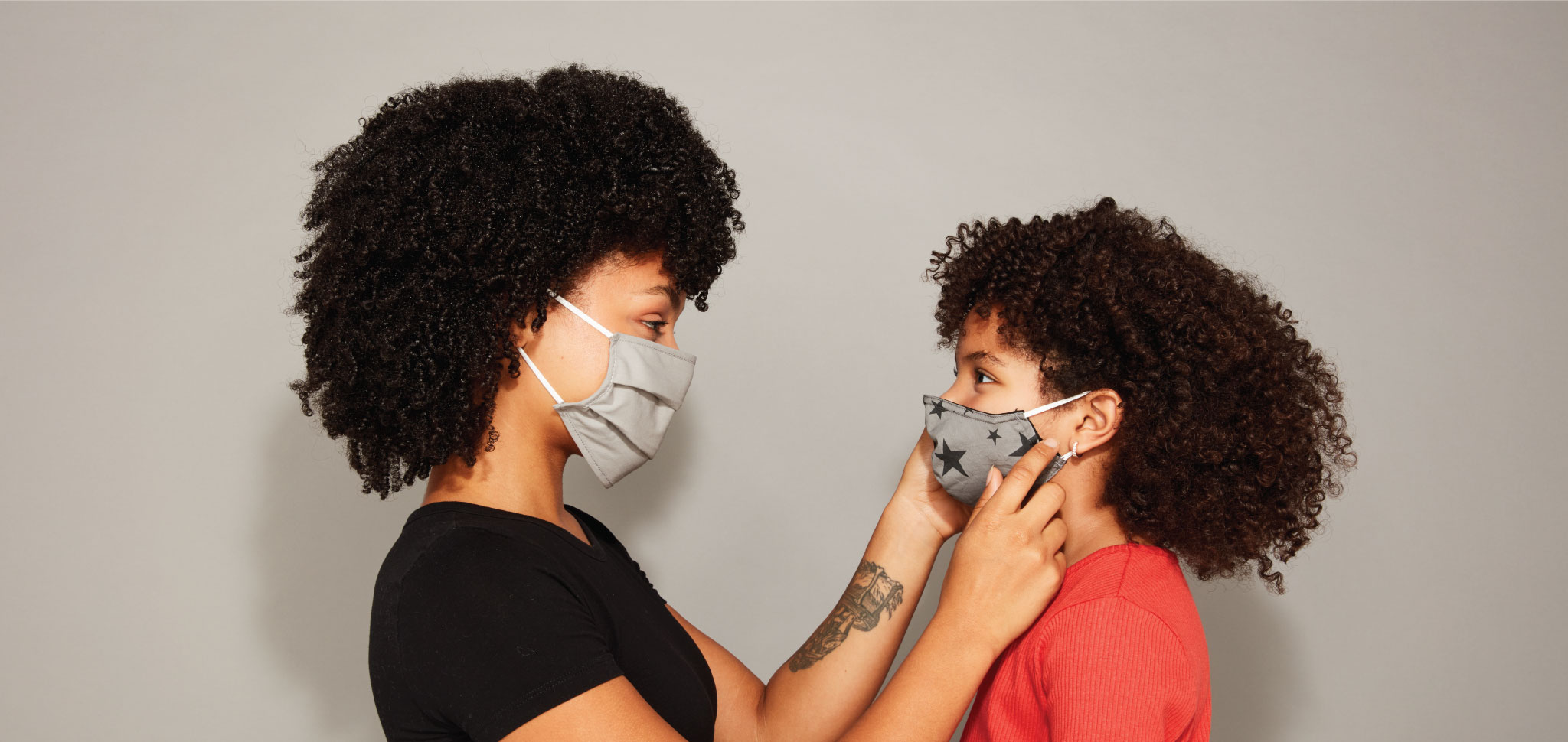 Two people wearing masks